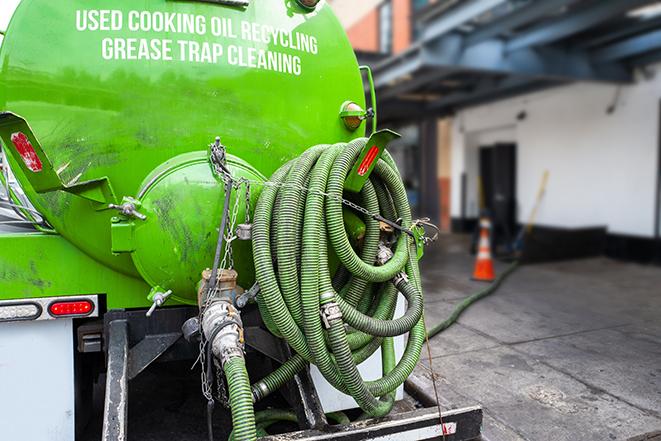 maintenance crew pumping grease trap at a fast food restaurant in Bloomfield